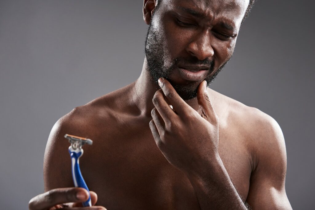 black man shaving razor