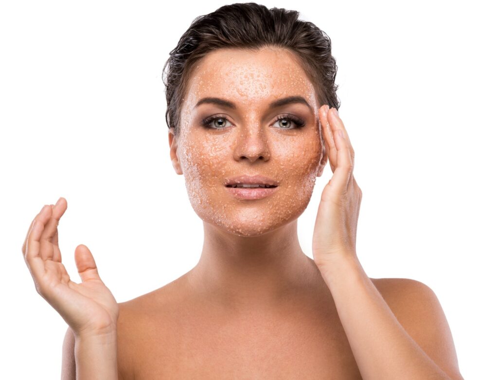 woman exfoliating face
