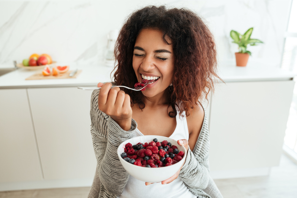 woman eating berries