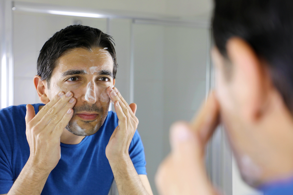 man washing face